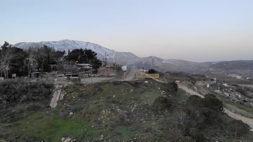 Aerial view over snowy Hermon Mountain and small village