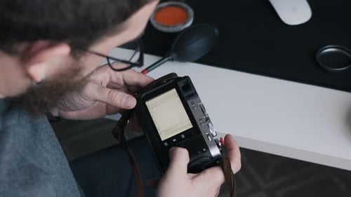 Photographer Reviewing Images on Digital Camera Screen