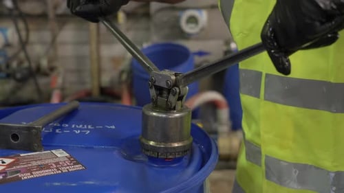 Travailleur sécurisant le tambour de refroidissement avec un outil manuel dans une usine de fabrication industrielle