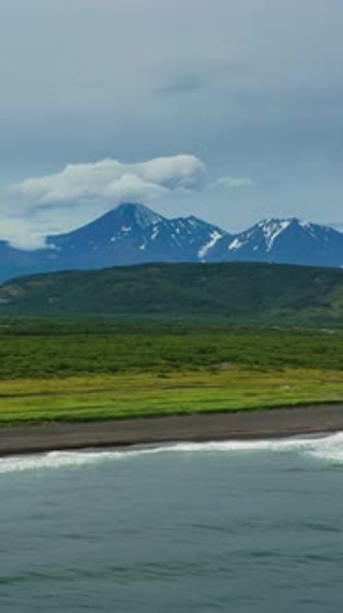 Beach with black sand and volcano