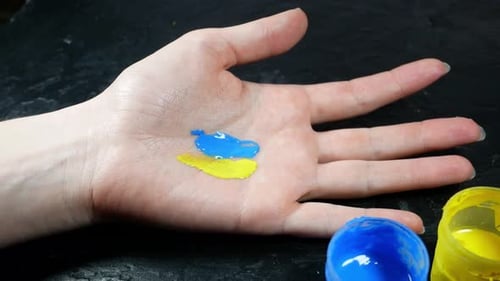 Close Up of Hand Mixing Paints