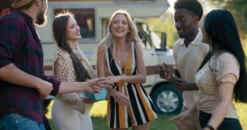 Diverse Friends Dancing Together Outdoors by Camper