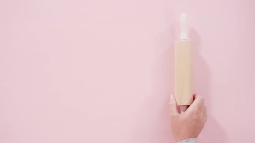 Rolling Pin and Whisk on Pink Background