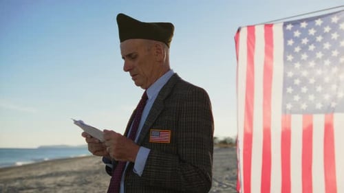 Vietnam War Veteran Reads Speech For The Fallen On The Beach Near The Ocean