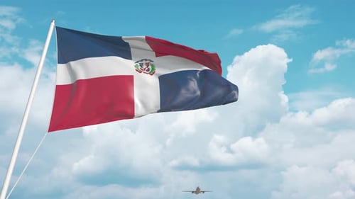 Commercial Airplane Landing Behind the Dominican National Flag