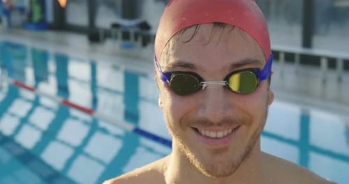 Smiling Swimmer in Cap and Goggles Close-Up