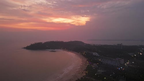 Aerial Hyperlapse of Vibrant Sunset Over Coastal Landscape Ocean Waves Meet Shoreline During Dusk As