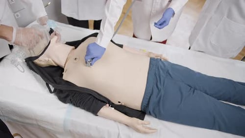 Medical Training with Mannequin in Hospital Room