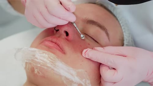 Woman Receiving Facial Treatment in Beauty Salon