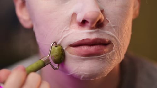 Close-up female portrait. a young girl performs beauty rituals at home