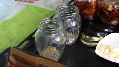 Woman Prepares Sun Dried Tomatoes With Herbs