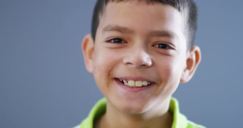 4k video footage of an adorable little boy smiling against a blue background
