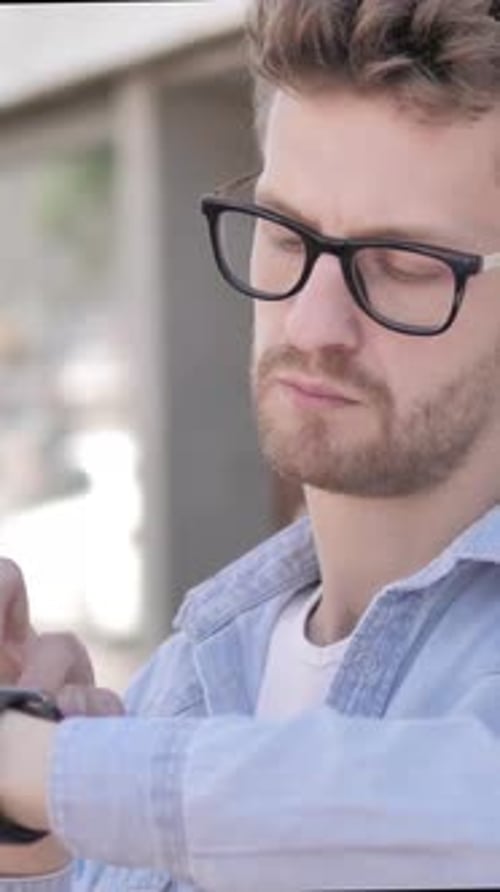 Young Man Using Smartwatch in City, Technology Concept
