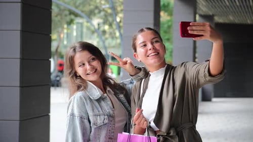 Two Women Taking Selfie After Shopping in City