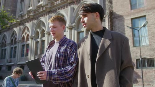 Two Male Students Talking on a Walk on College Campus