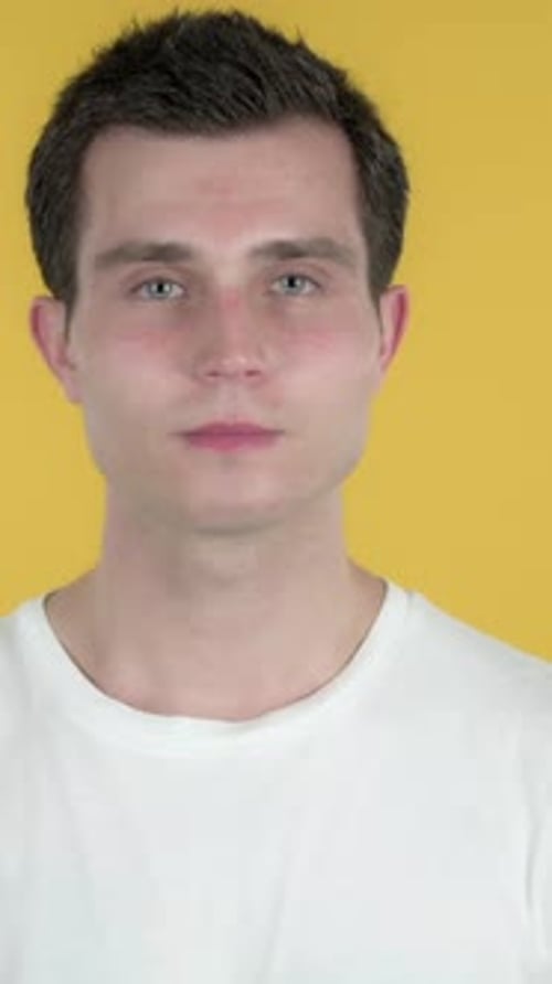 Man Inviting Customers with Both Hands, Yellow Background, Vertical Video