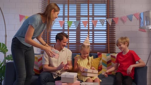 Happy Girl Receives Birthday Gifts from Family