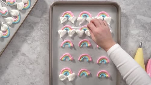 Flat Lay Step By Step Piping Meringue Mix Into Unicornshaped Pops on a Baking Sheet Lined with