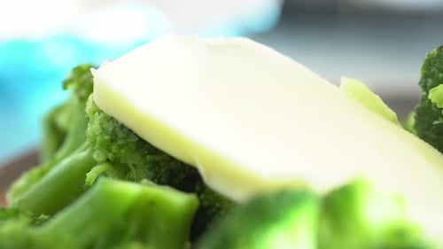 Fresh Broccoli with Melting Butter Close Up