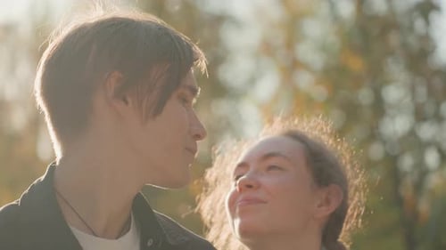 Sunlit Duo Explore Tranquil Park Scenery Hand in Hand Radiant Partners Meander Through Serene Park