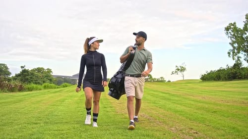 People Walking at Golf Course Look to Play Game with Ball and Carry Clubs in Bag