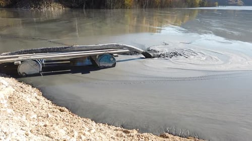 Mining Residuals Flowing into Decanting Pond from a Copper Mine. Geamana, Rosia Montana, Romania