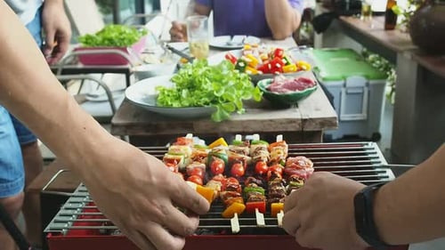 Backyard Barbecue with Friends and Family Cooking Skewers