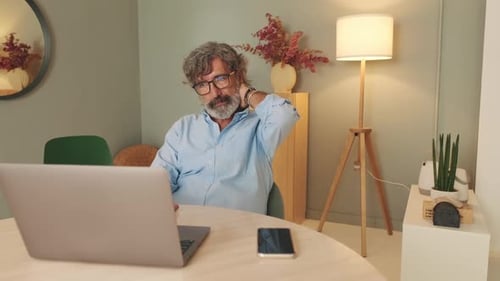 Adult Working on Laptop From Home Office