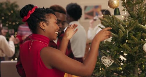 Friends Decorating a Christmas Tree Together