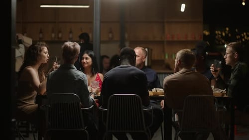 Young People Of Different Nationalities Dinning In Restaurant Clinking Glasses Friends Meeting
