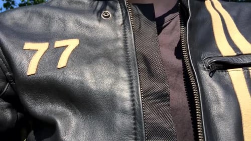 Closing zipper on motorcycle leather jacket.