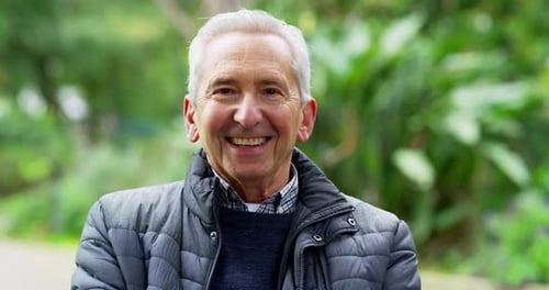 A happy senior man relaxing in the park