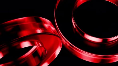 Red metallic rings rotating on black background