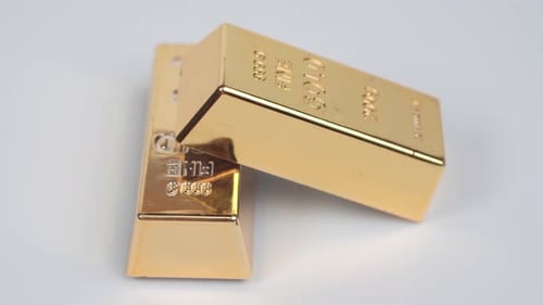 Two gold bars rotating on a white background