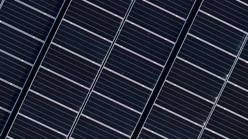Aerial drone view of solar panels. Photovoltaics on top of the roof of the building. Alternative ele