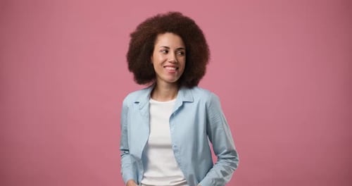 Smiling Attractive African American Woman Standing Over Pink Studio Background