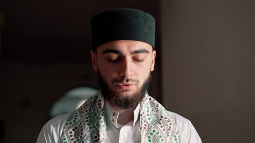 Porträt eines muslimischen Mannes, der im Ramadan auf den Knien betet und sich für Unterstützung und Spiritualität dankt