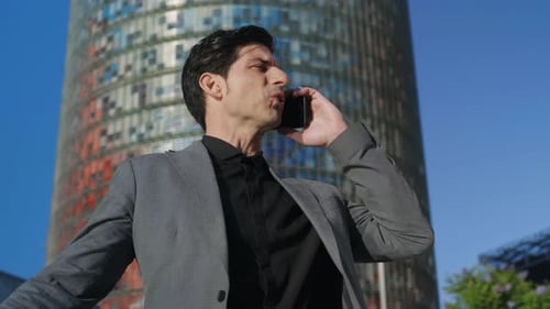 Upset Businessman Talking on Phone at Street. Portrait of Confident Entrepreneur Calling