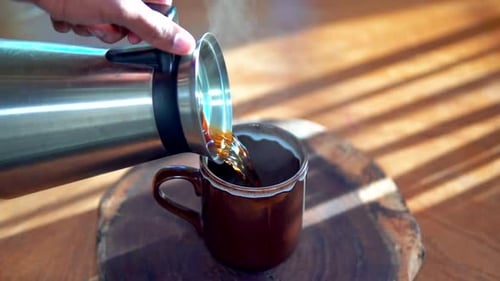 Pouring Fresh Coffee into a Mug