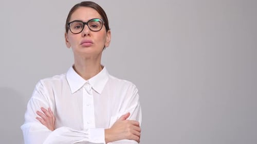 Business MiddleAged Woman With Glasses Poses Over Grey Background