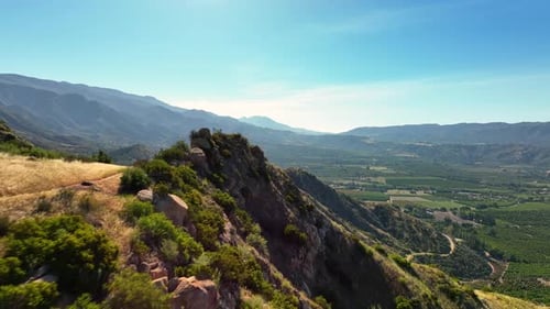 Stunning mountain view overlooking a green valley from a rocky outcrop
