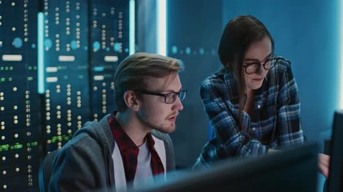 Male and Female Programmers Talking, Solving Problem, Using Computers. Software Development / Code