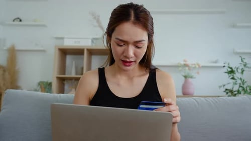 Young asian female hands of cardholder holding credit card making e bank online payment.
