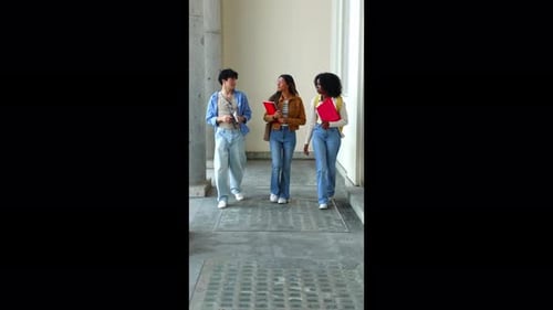 Diverse University Students Walking Together in Campus Hallway