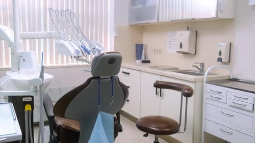 Empty Modern Light Dentist Office in Clinic with Equipment Computer Professional Dental Chair and