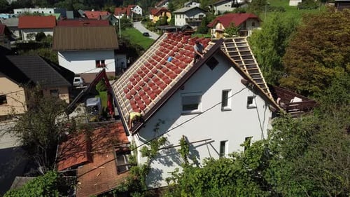 Roofers Install Orange Tiles on House Roof