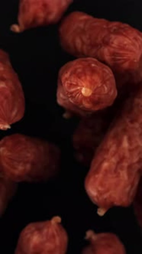 Mini Salami Fly and Fall on a Black Background Filmed on a Highspeed Camera at 1000 Fps