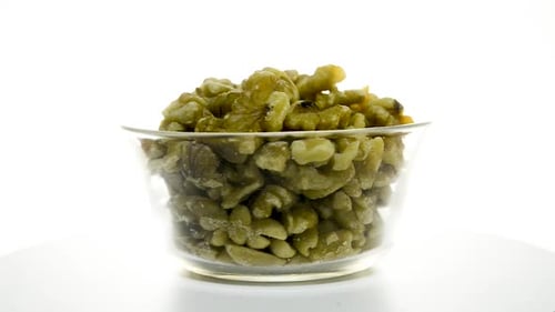 Peeled Walnuts Rotating in Clear Glass Bowl