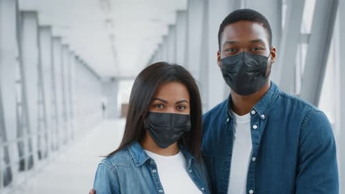 Young African American Couple at the Airport Wearing Masks During Travel
