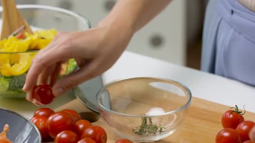 Woman Prepares Healthy Salad with Fresh Tomatoes